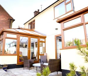 Conservatory with uPVC oak coloured windows and doors
