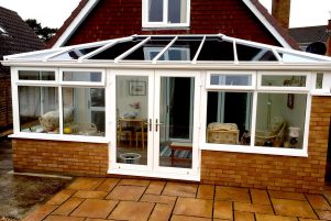 White conservatory installation in Edwardian style with brick base and uPVC windows