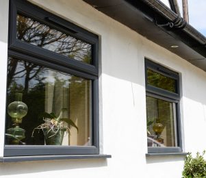 Grey double glazed uPVC windows with top hung opening