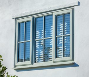 Green traditional style windows with uPVC cross bars