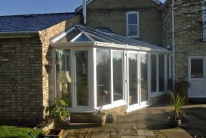 A conservatory with a pitched roof in lean-to style