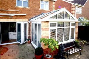 A small conservatory with a gable style glass roof