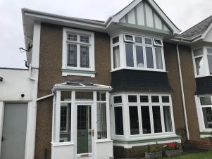 Front of house white UPVC door porch and windows